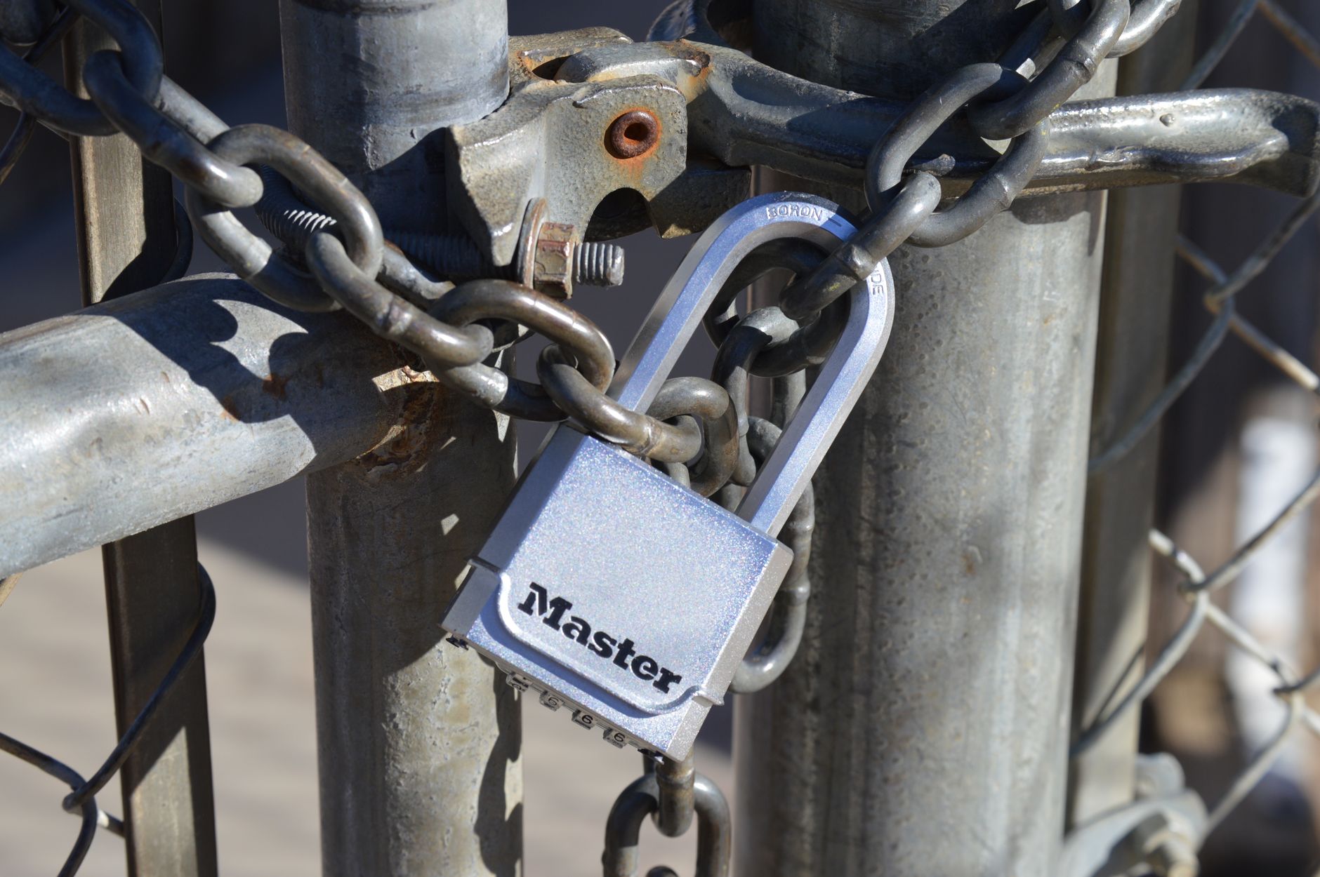 A padlock securing a metal gate with a chain, representing the safety review hooks deserve before running
