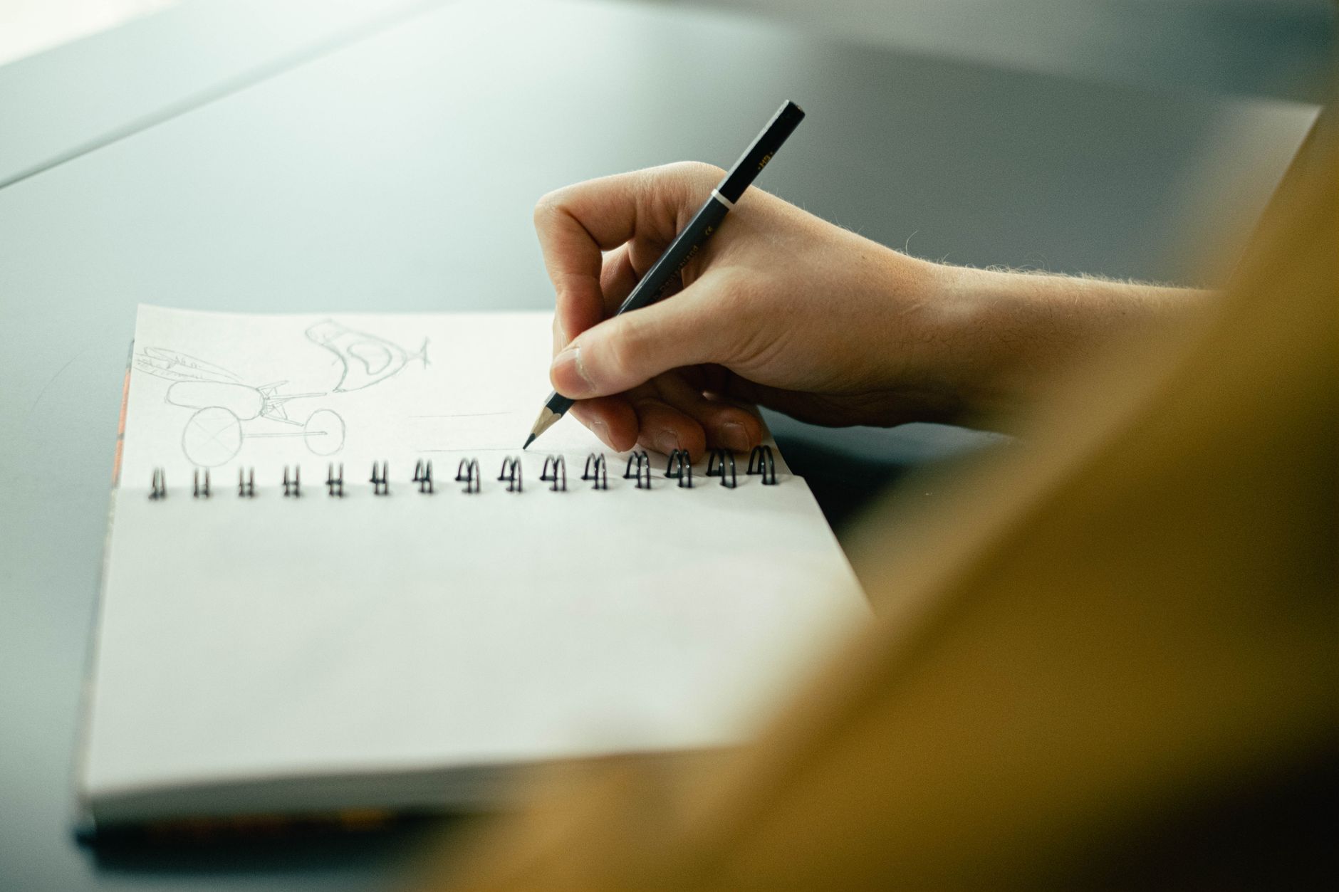 Hand sketching a plan in a notebook