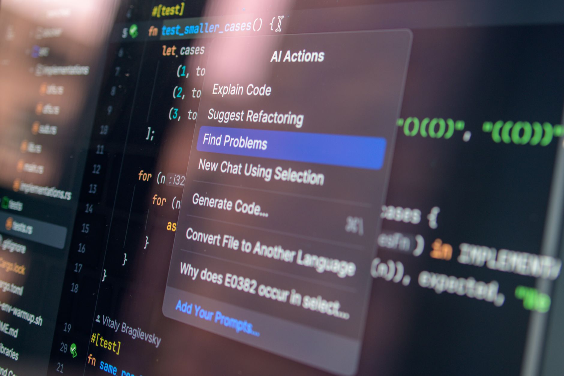 Close-up of AI-assisted coding and debugging on a laptop screen